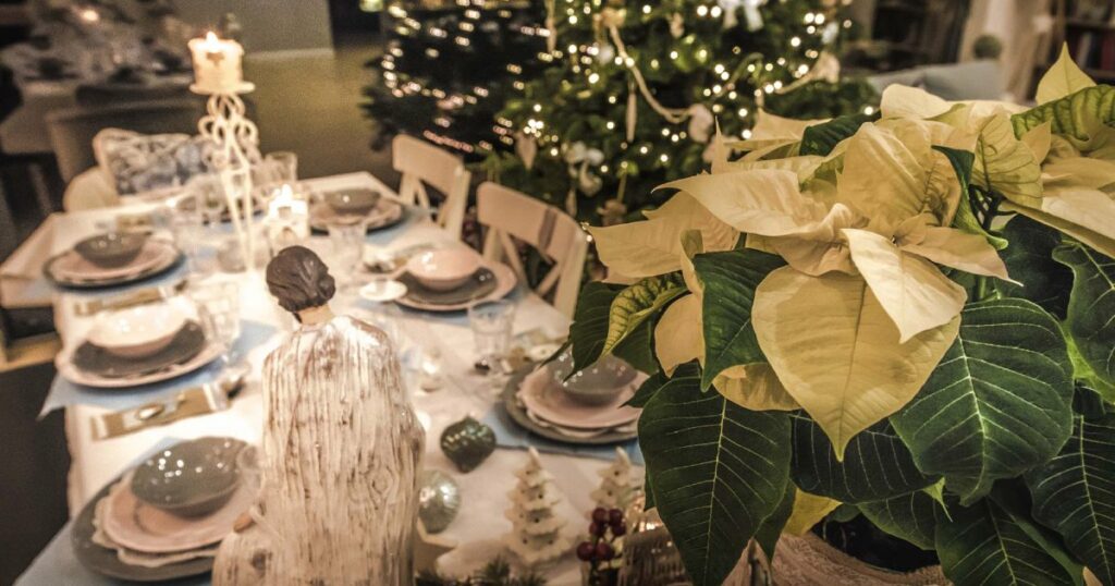 Betlēmes zvaigzne virs Kristus dzimšanas ainas ar svēto ģimeni uz Ziemassvētku galda